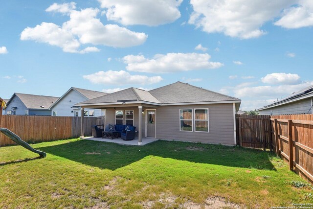 rear view of house with a patio and a yard