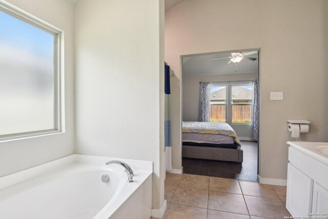 bathroom with vanity, tile patterned flooring, ceiling fan, and a tub