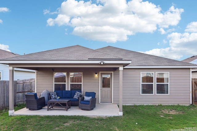 rear view of house featuring a patio, an outdoor living space, and a yard