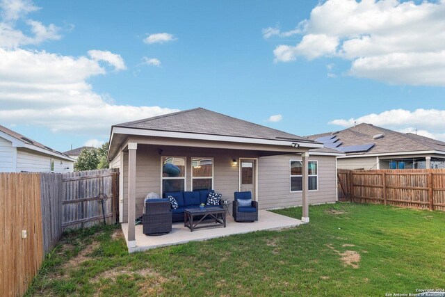 back of house featuring a patio, a yard, and an outdoor hangout area