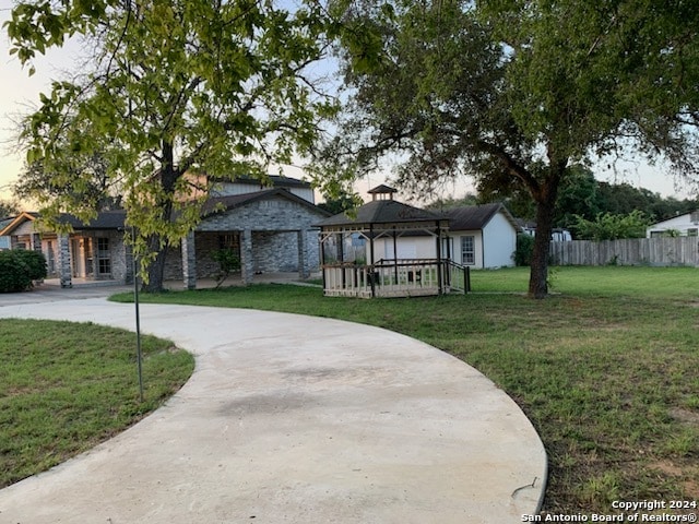 view of front of property with a gazebo and a front yard