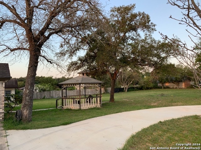 surrounding community with a gazebo and a lawn