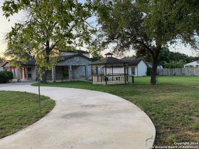 surrounding community with a gazebo and a yard