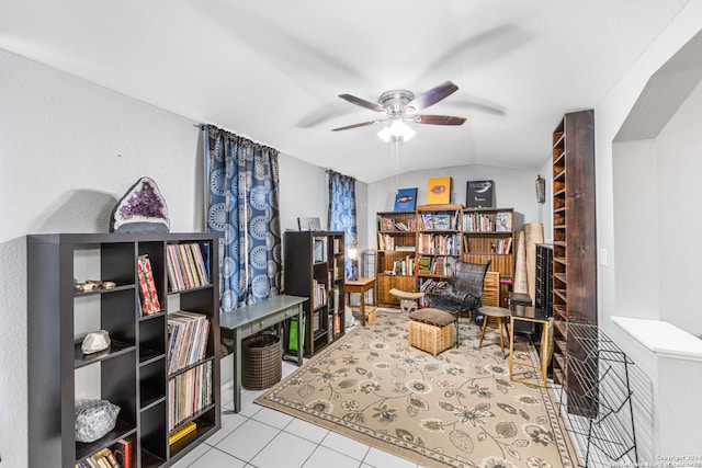 tiled home office with ceiling fan and vaulted ceiling