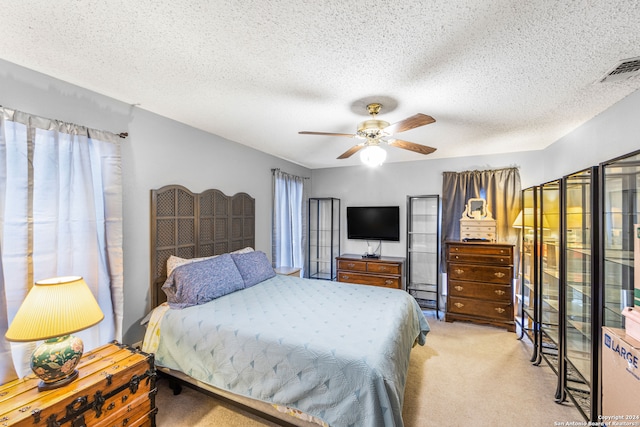 carpeted bedroom with a textured ceiling and ceiling fan