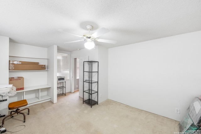 misc room featuring light carpet, a textured ceiling, and ceiling fan