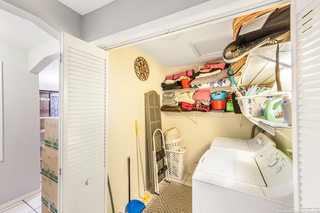 clothes washing area featuring washing machine and clothes dryer and light tile patterned floors