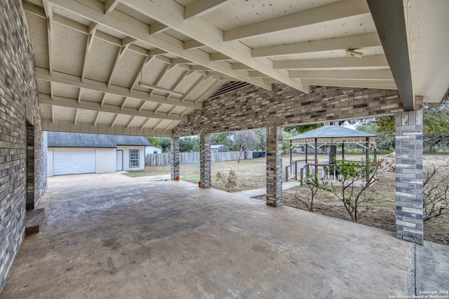 view of patio featuring a gazebo and an outbuilding