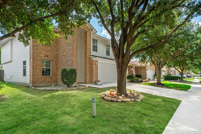 view of front of property with a garage and a front lawn