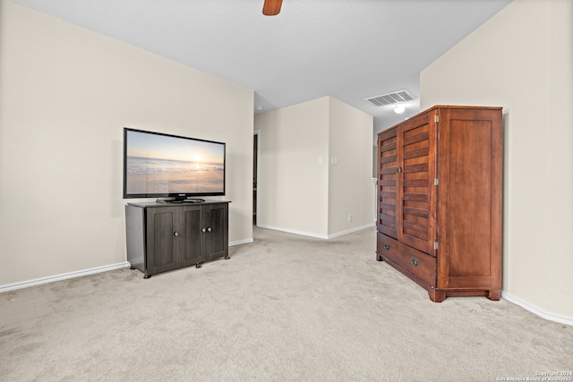 unfurnished living room featuring ceiling fan and light colored carpet