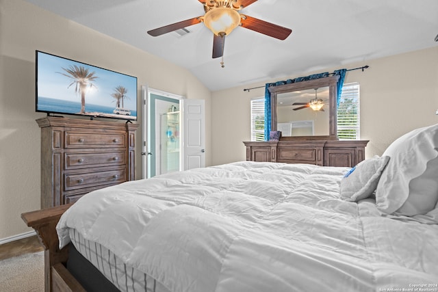 carpeted bedroom with ceiling fan and vaulted ceiling