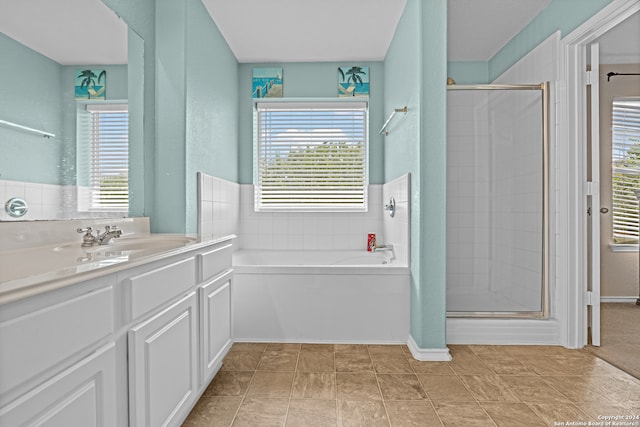 bathroom featuring vanity, plus walk in shower, and tile patterned floors