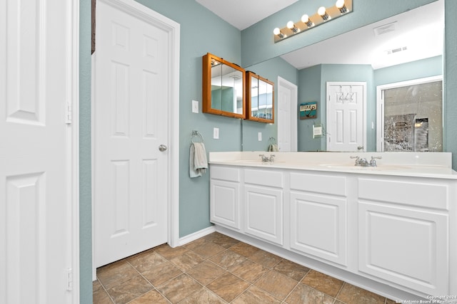 bathroom with tile patterned flooring and dual vanity