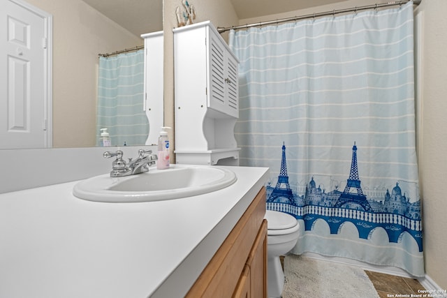 bathroom featuring vanity, tile patterned flooring, and toilet