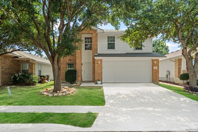 view of front of property with a garage, a front lawn, and central AC unit