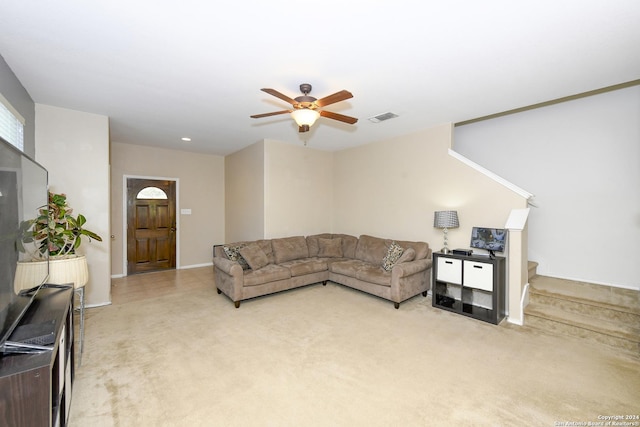 carpeted living room with ceiling fan