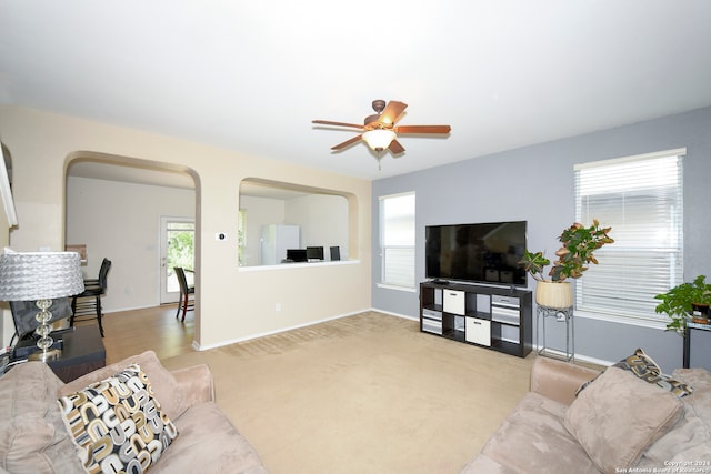 living room featuring ceiling fan and light colored carpet