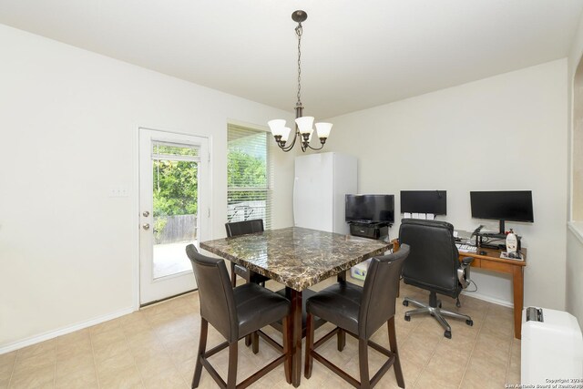 tiled dining area with an inviting chandelier