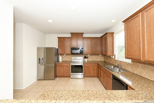 kitchen with dishwashing machine, electric stove, stainless steel fridge with ice dispenser, sink, and backsplash