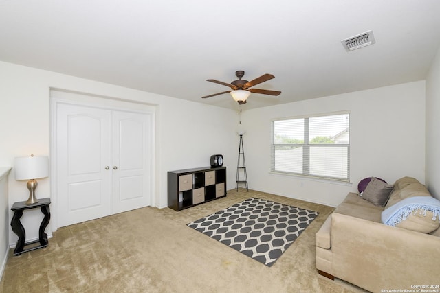 living room featuring ceiling fan and carpet floors