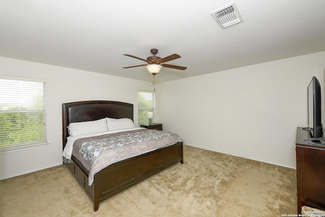 bedroom with ceiling fan and light colored carpet