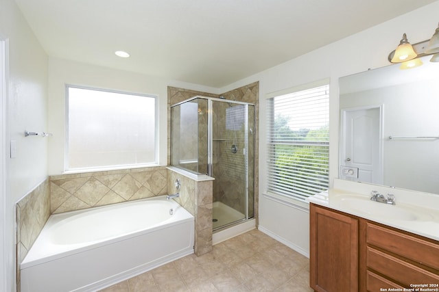 bathroom featuring vanity and shower with separate bathtub