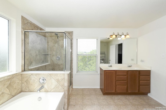 bathroom with vanity and independent shower and bath