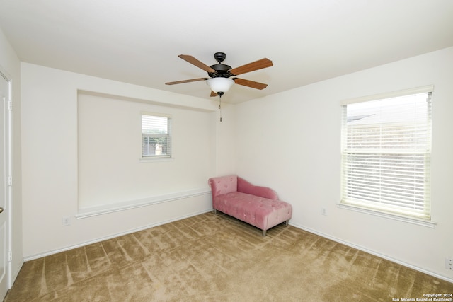 unfurnished room with light carpet and ceiling fan