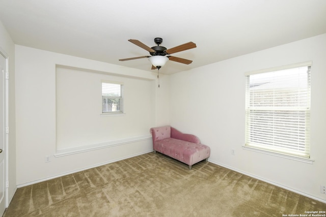 unfurnished room with ceiling fan and light colored carpet