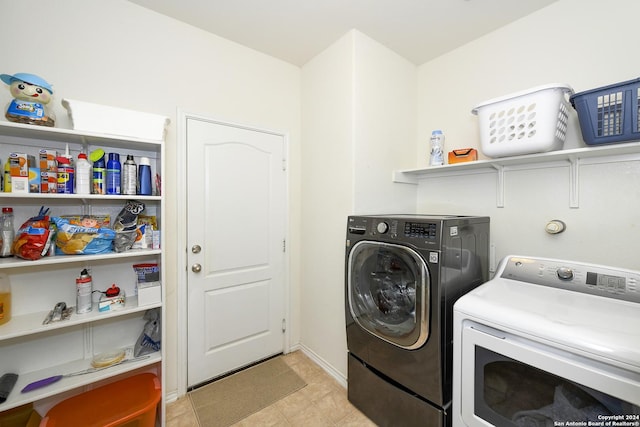 clothes washing area featuring separate washer and dryer and light tile patterned floors