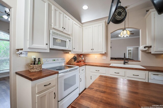 kitchen with sink, white cabinetry, wood counters, and white appliances