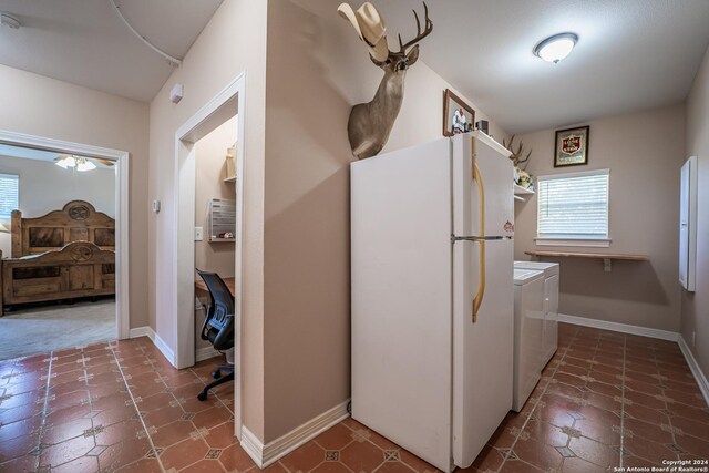 kitchen with white fridge, tile patterned floors, and washing machine and dryer