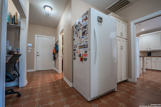 hall featuring dark tile patterned floors