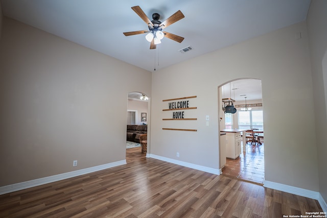 tiled spare room with ceiling fan