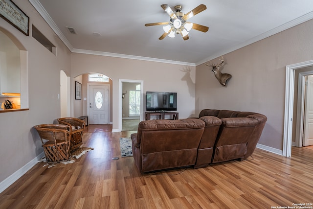 living room with ornamental molding, hardwood / wood-style flooring, and ceiling fan