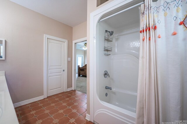 bathroom with shower / tub combo, tile patterned flooring, and ceiling fan