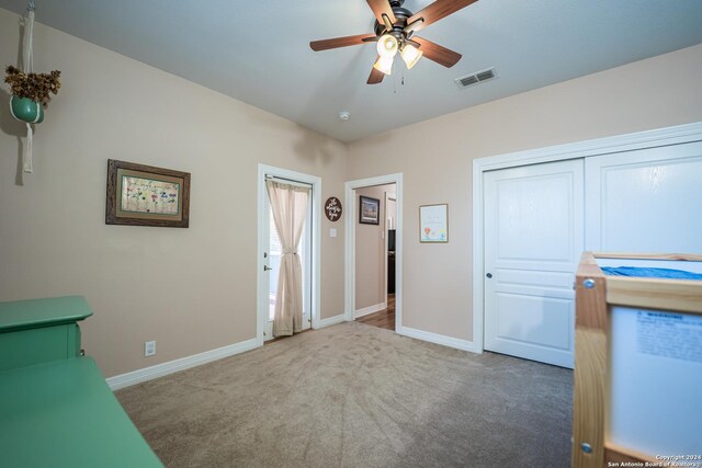 unfurnished bedroom featuring carpet, ceiling fan, and a closet