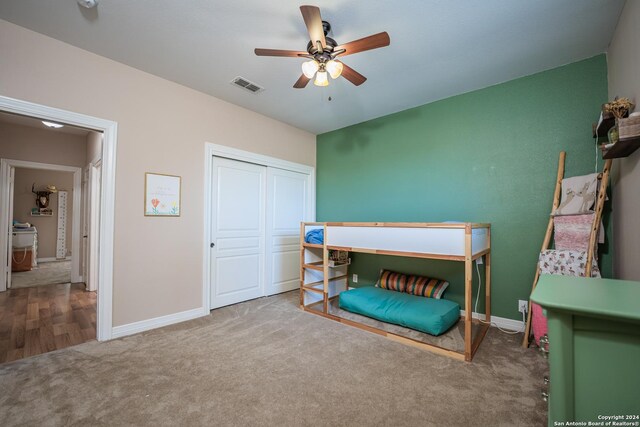 carpeted bedroom with a closet and ceiling fan