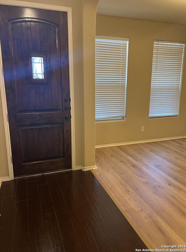 foyer with dark hardwood / wood-style floors