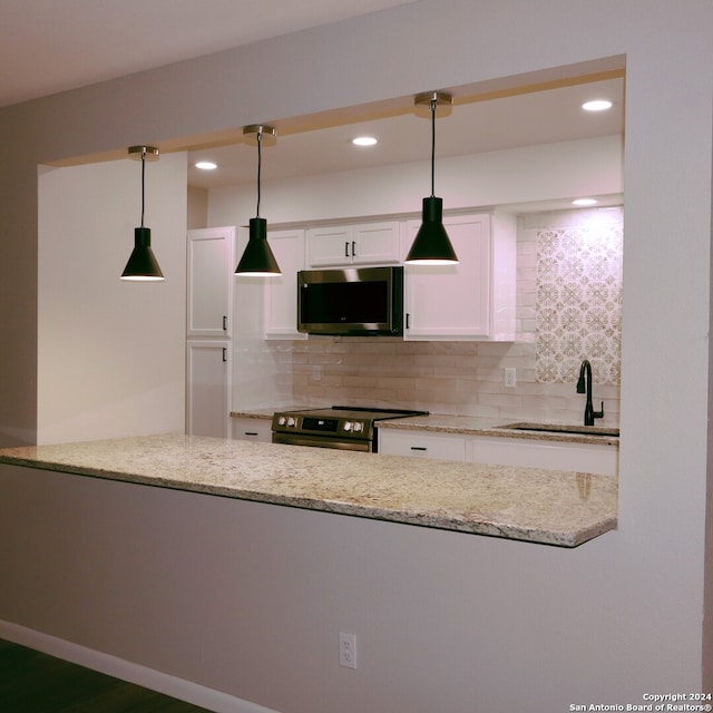 kitchen with white cabinets, stainless steel appliances, sink, and decorative backsplash