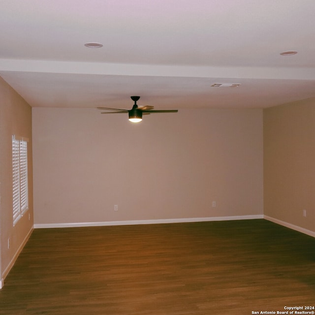 empty room with hardwood / wood-style flooring and ceiling fan