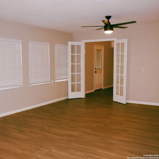 empty room featuring dark wood-type flooring and ceiling fan