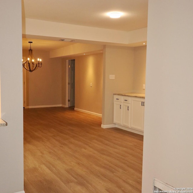 unfurnished dining area featuring dark hardwood / wood-style flooring and a notable chandelier