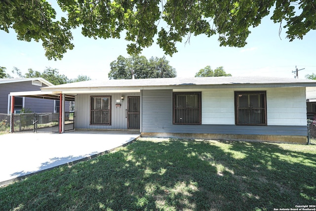 single story home with a carport and a front lawn