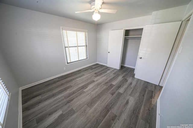 unfurnished bedroom with ceiling fan, dark hardwood / wood-style flooring, and a closet