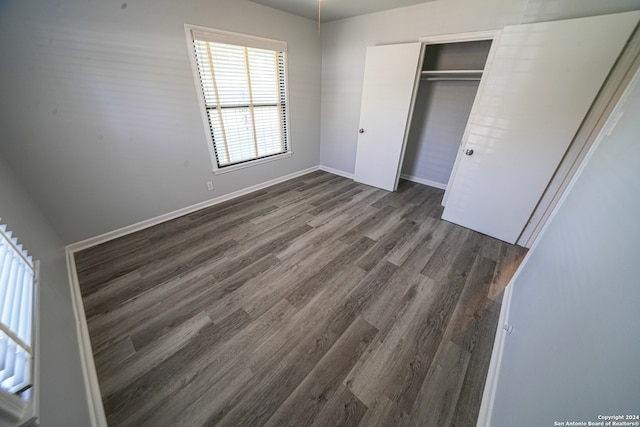 unfurnished bedroom featuring a closet and wood-type flooring