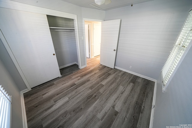 unfurnished bedroom with a closet and hardwood / wood-style flooring