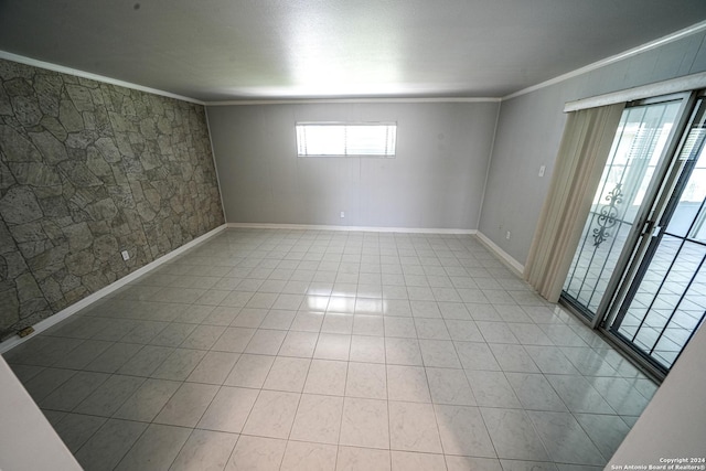 tiled empty room featuring ornamental molding