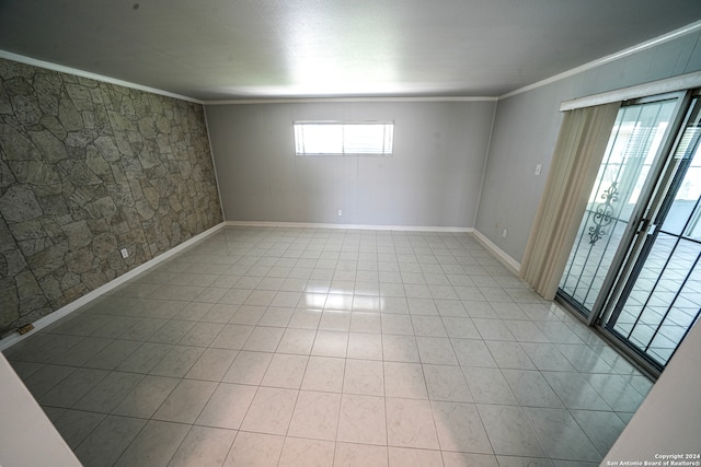 tiled empty room featuring crown molding