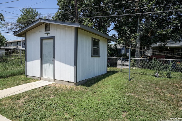 view of outbuilding with a lawn